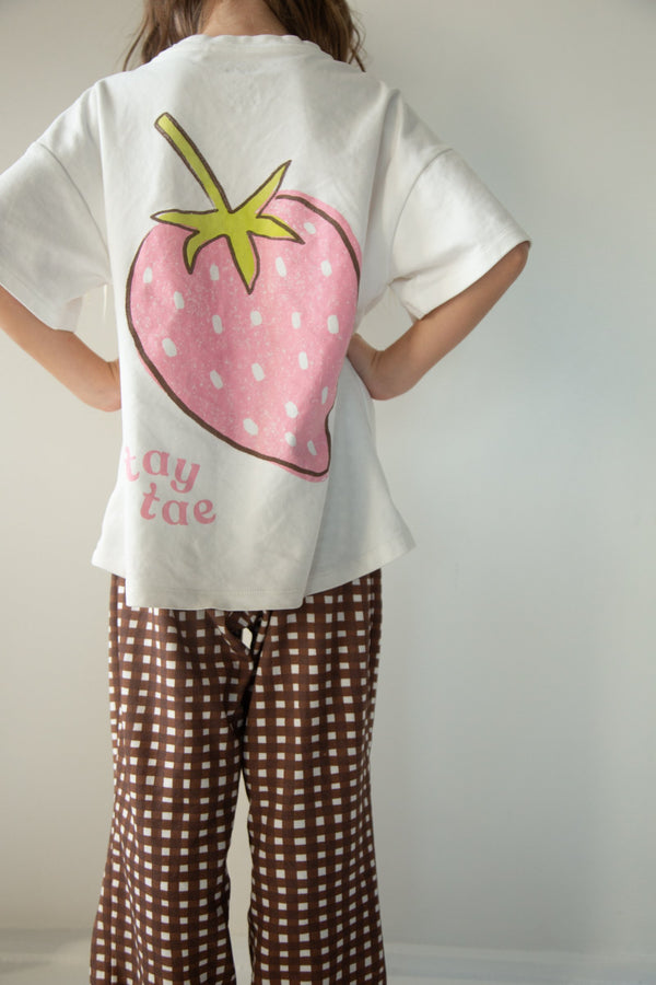 Back of the Sunday Set tee showing the oversized pink strawberry and tay tae script