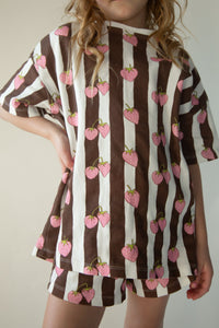 Close-up of the Berry Stripe Set print — pink strawberries on brown and cream stripes